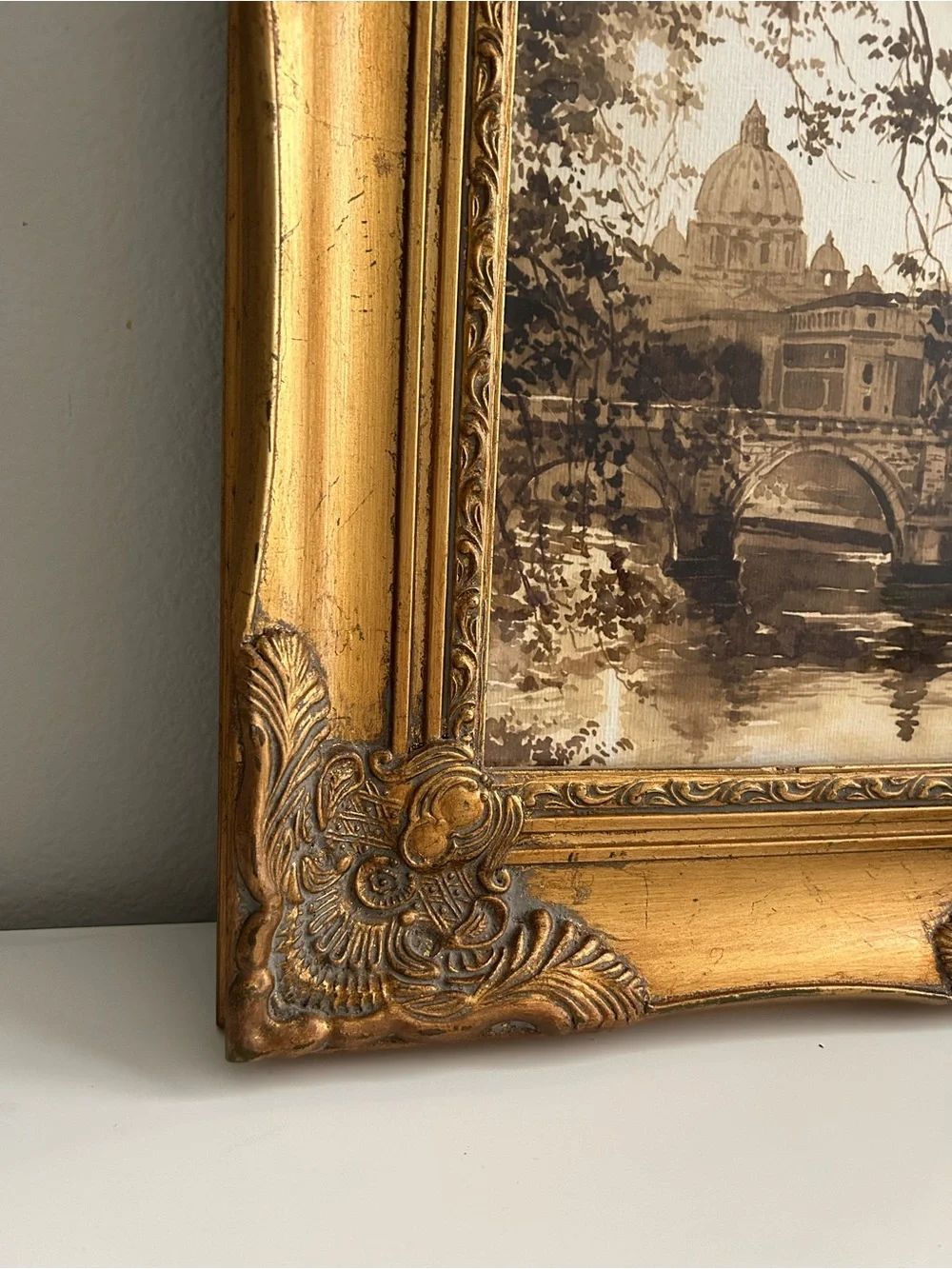 Framed art in gilded ornate frame